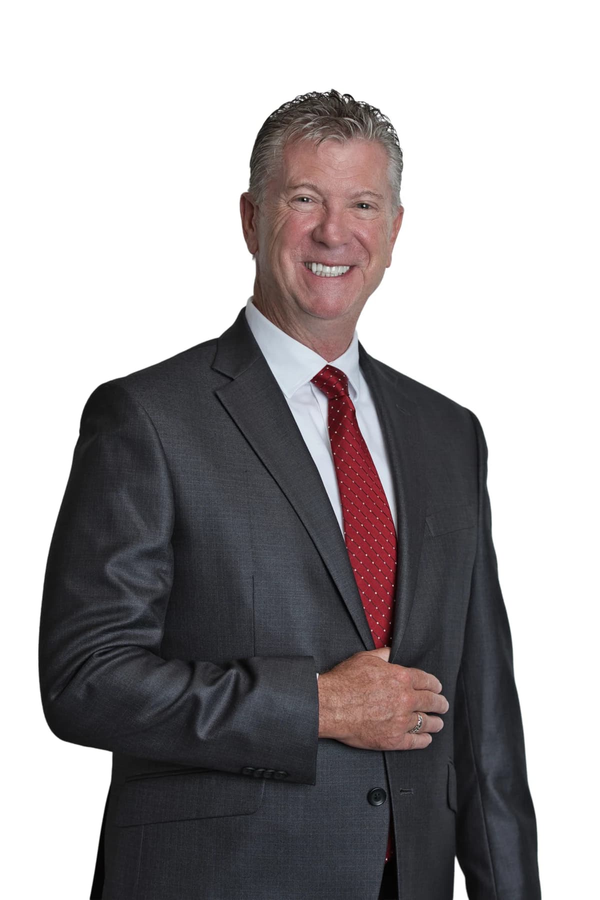 Bob Crews standing in a dark suit and red tie