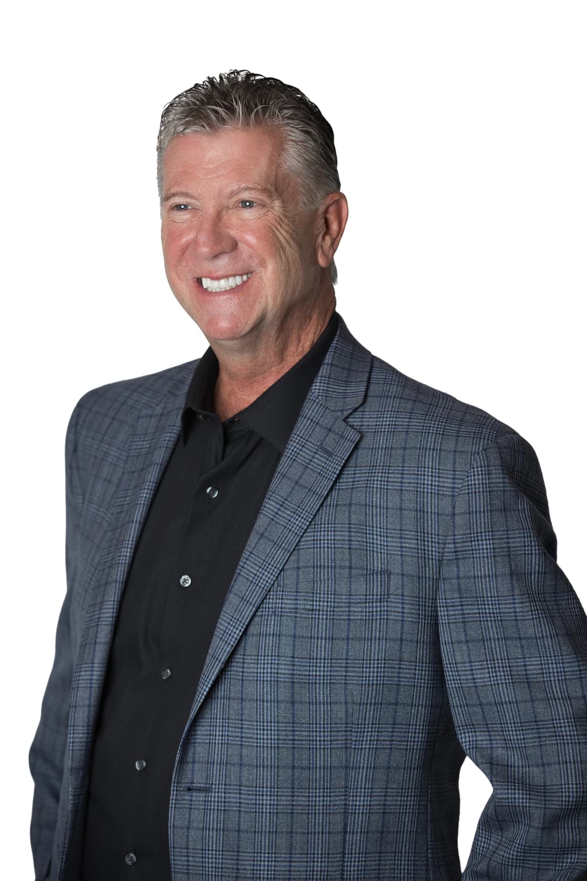 Bob Crews smiling in a blue checked jacket and black shirt
