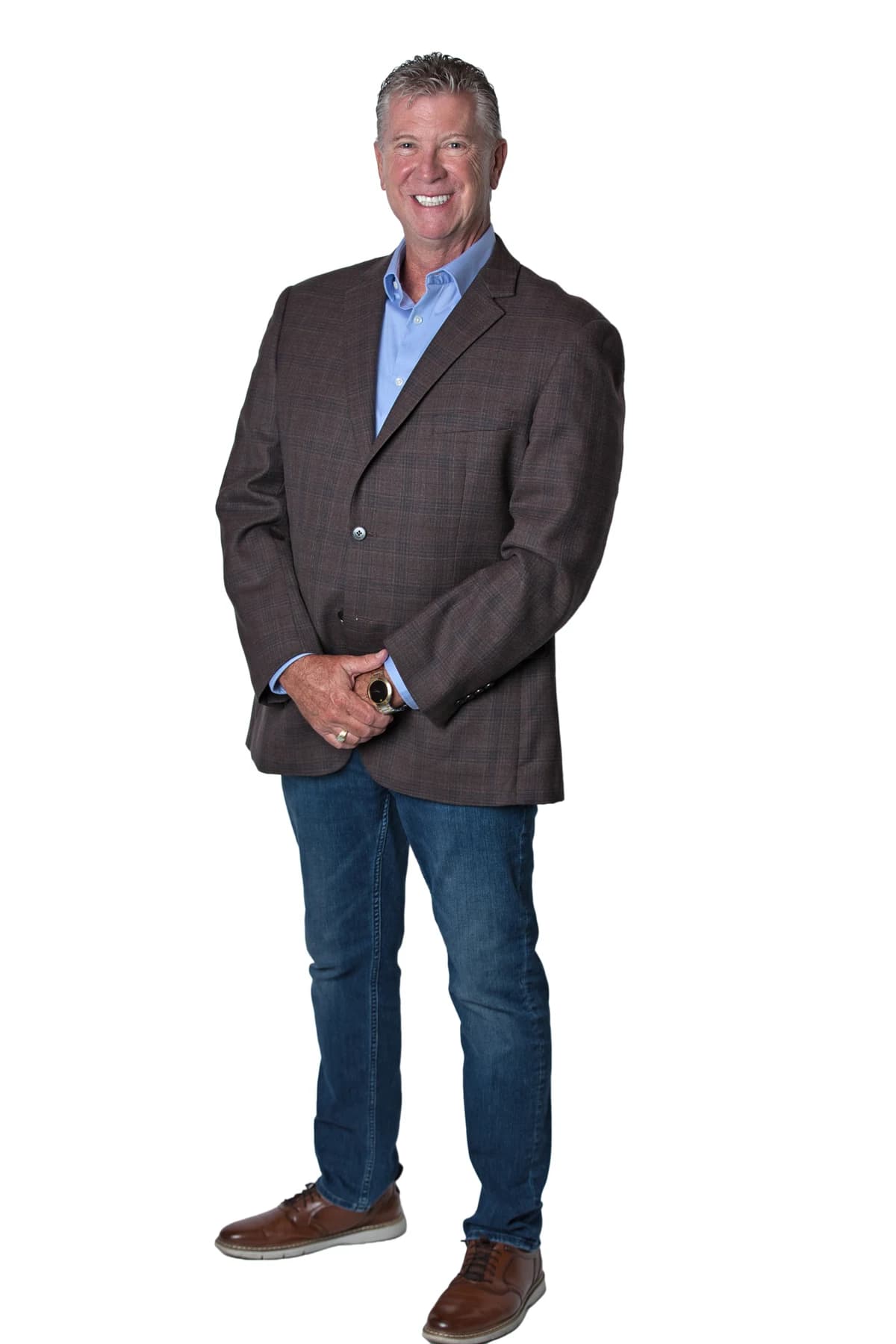 Bob Crews standing in a brown jacket, blue shirt and jeans