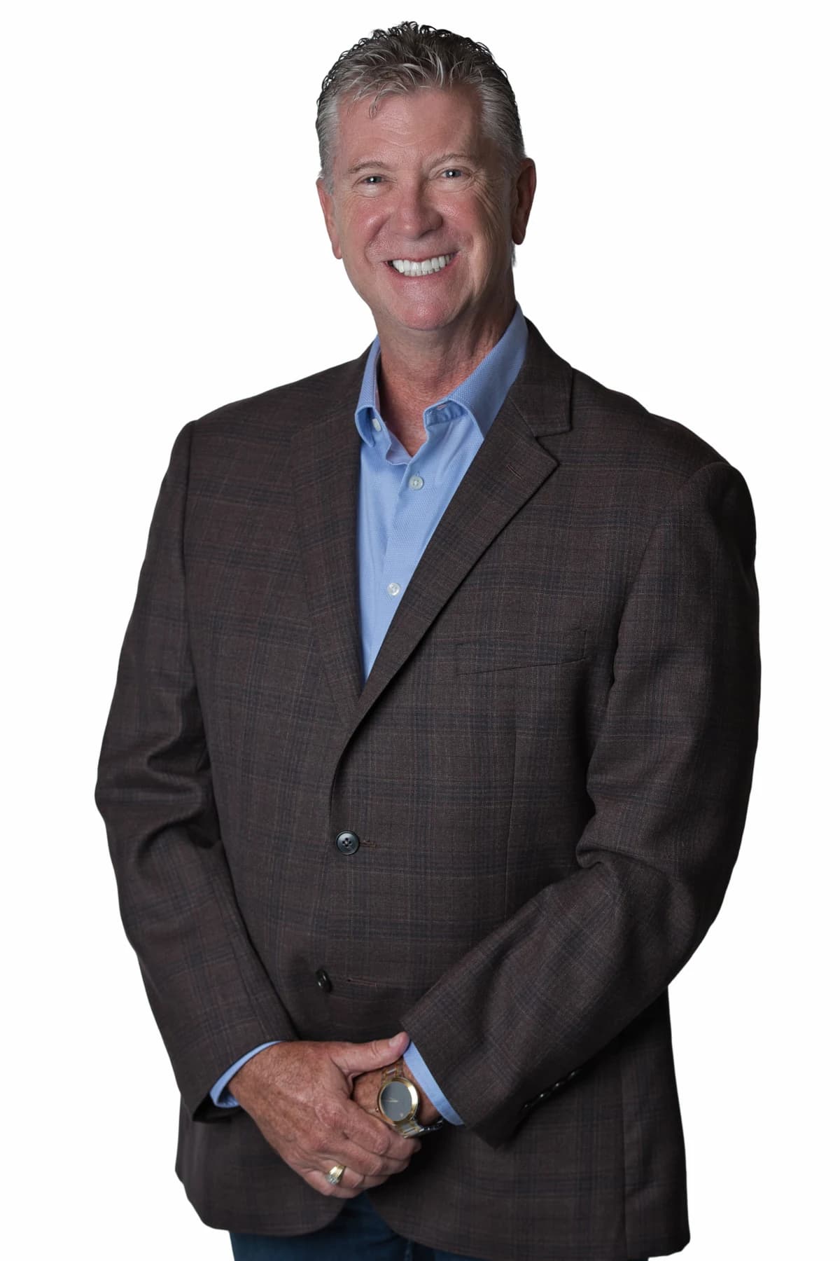 Bob Crews standing in a brown jacket and blue shirt