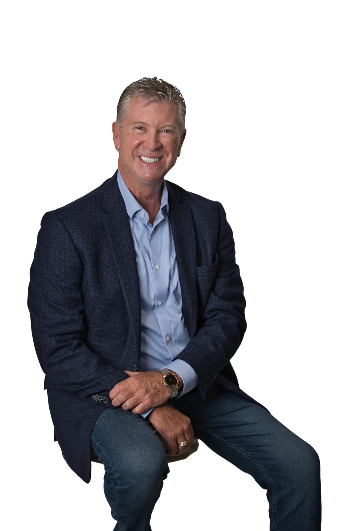 Bob Crews seated in a blue jacket, blue shirt and jeans