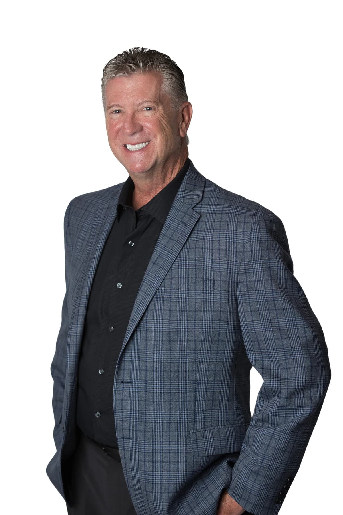 Bob Crews standing in a blue checked jacket and black shirt